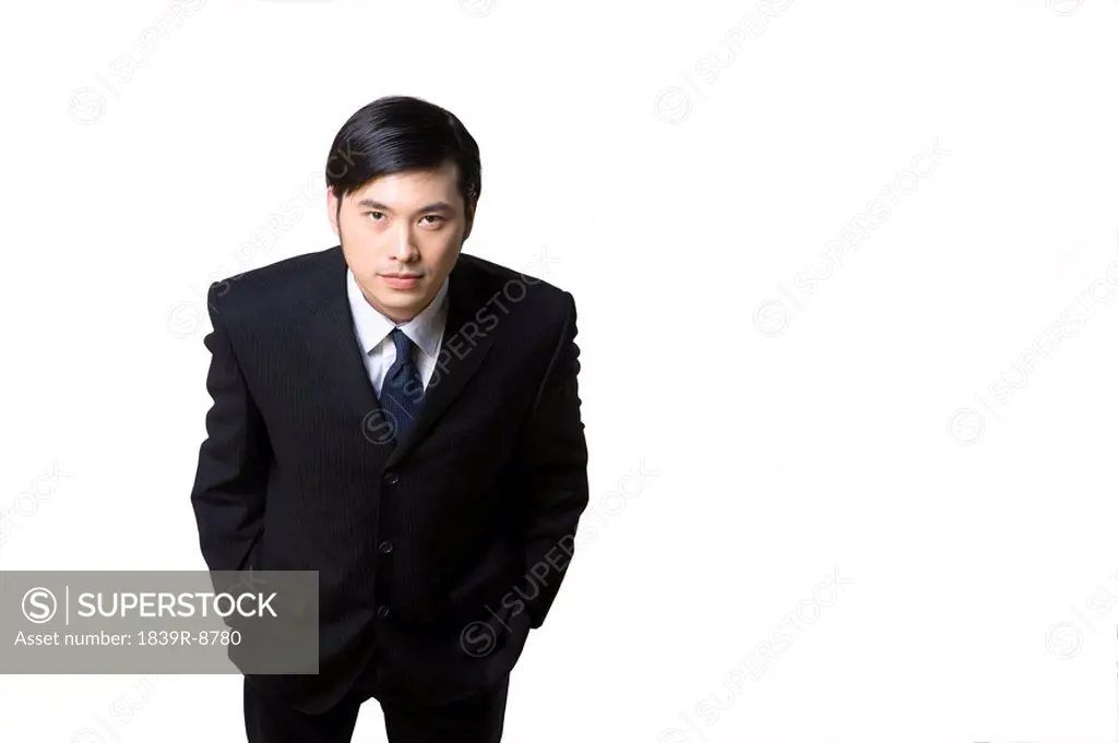 Businessman in dark suit on light background