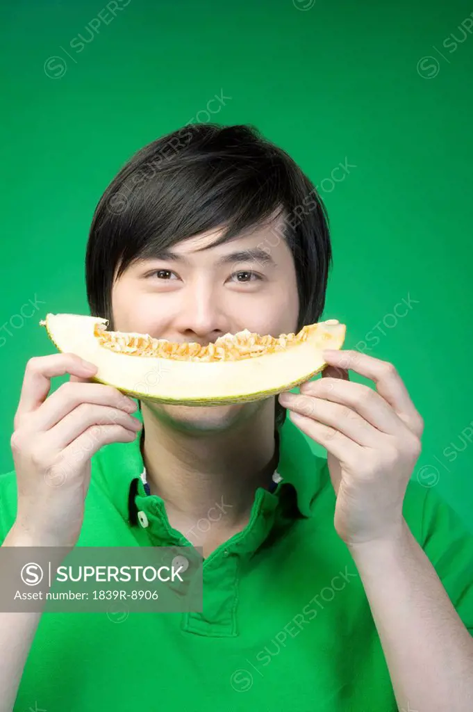 Man in green with melon