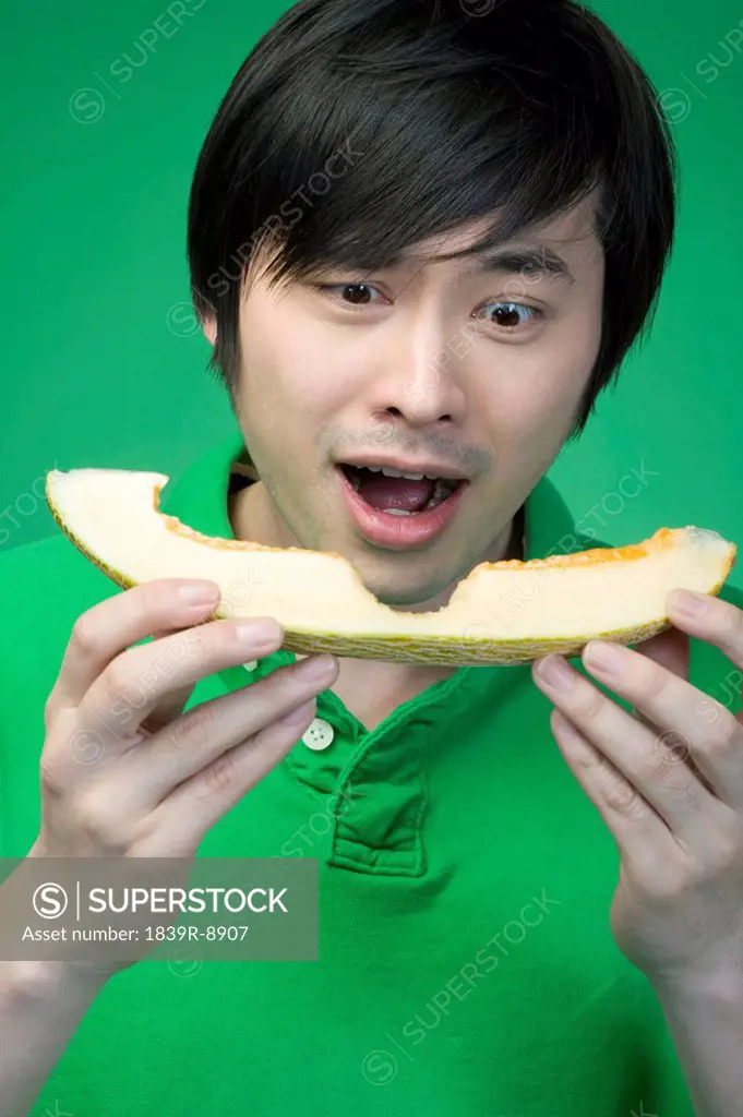 Man in green with melon
