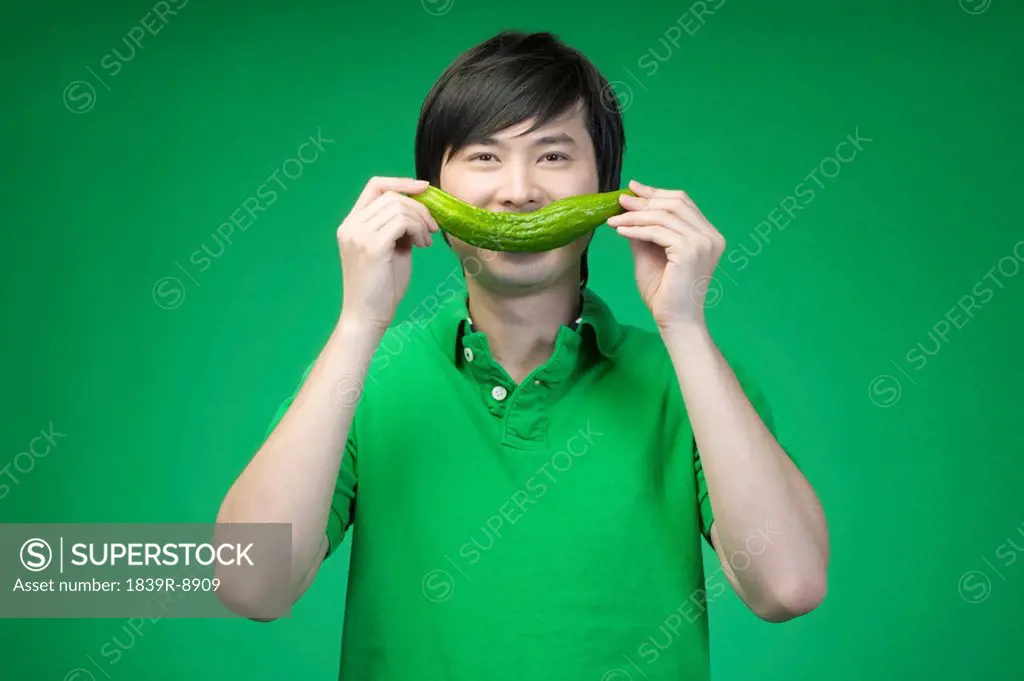 Man in green with cucumber