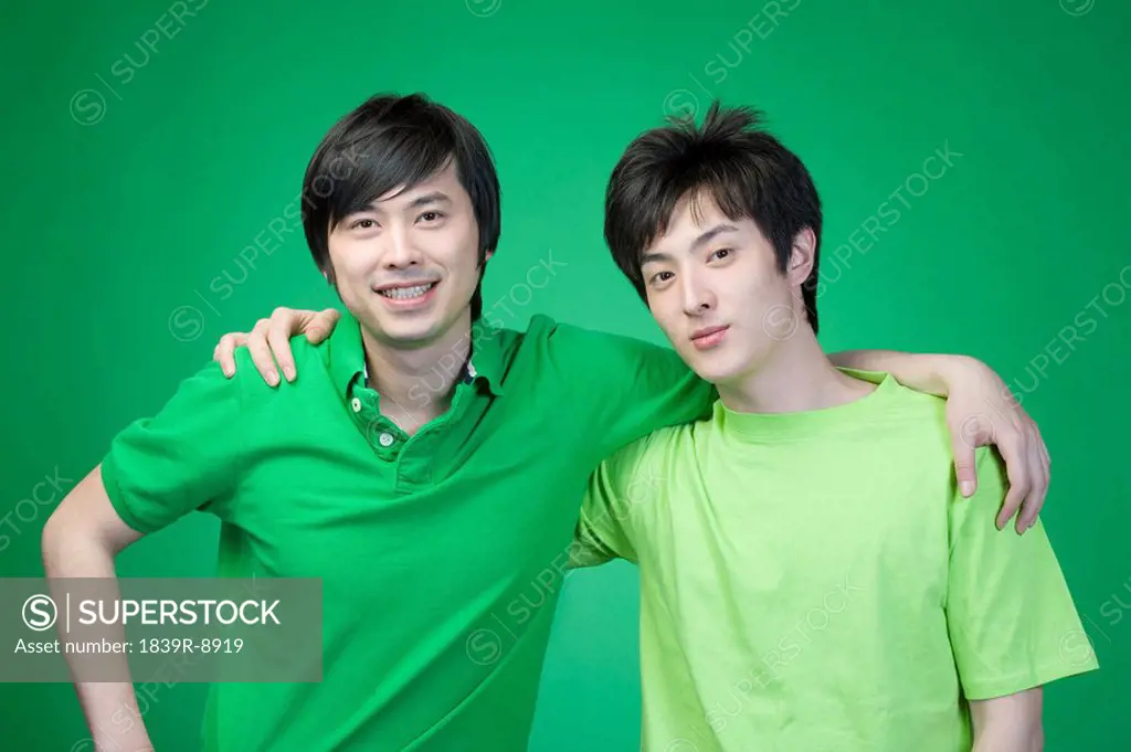 Two men in green on green background