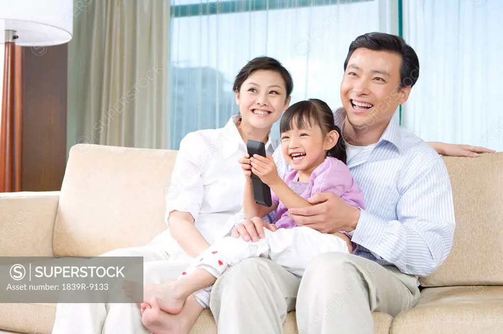 Couple with child on couch