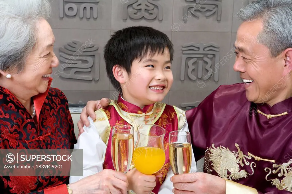 Chinese grandparents toasting grandson