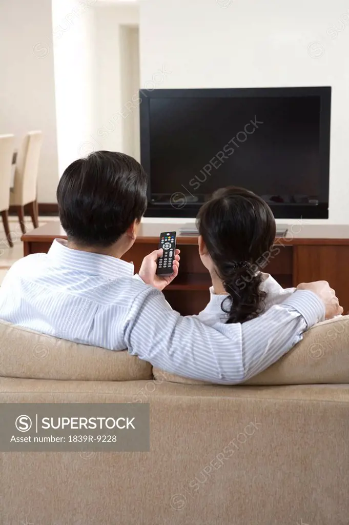 Couple in front of widescreen television