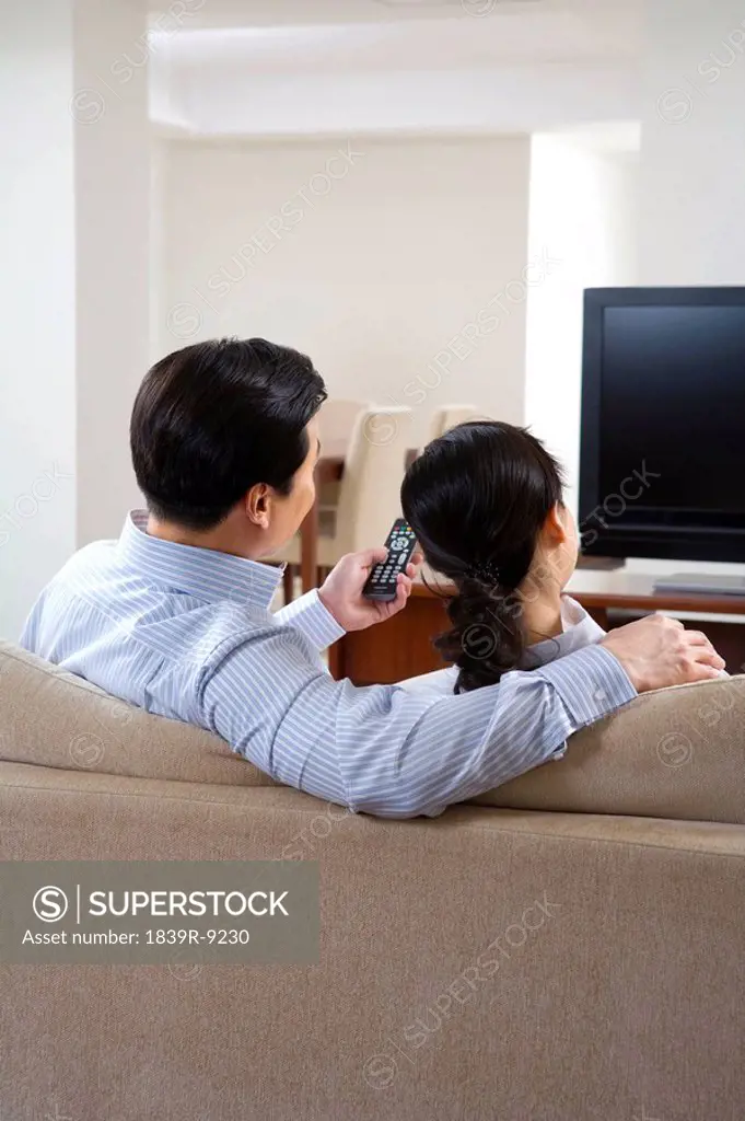 Couple in front of widescreen television