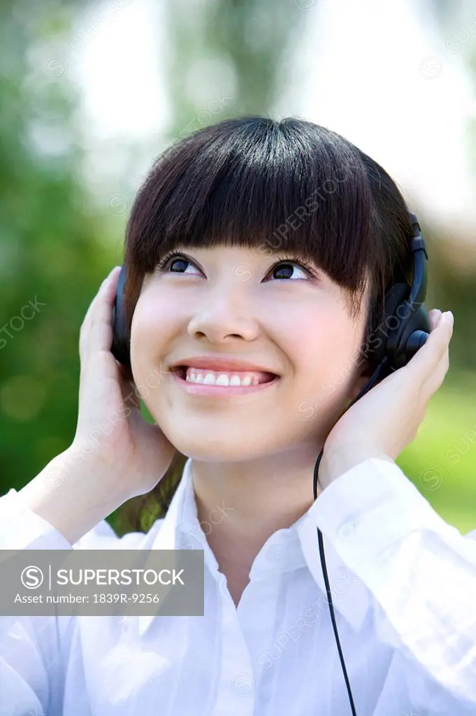 Woman in park with headset