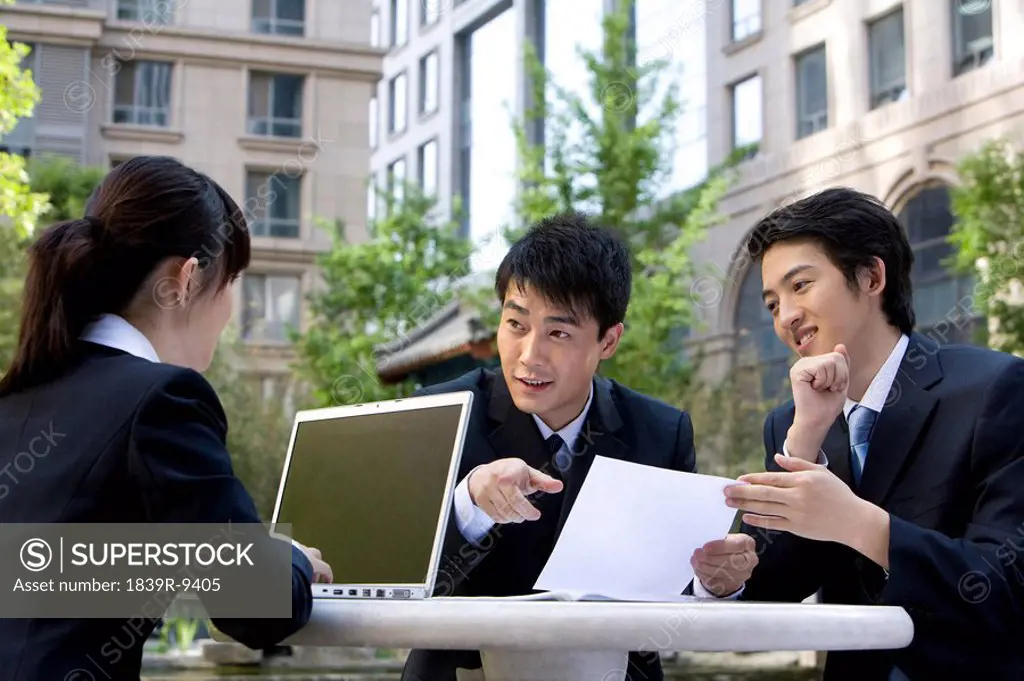 Three business professionals having a meeting