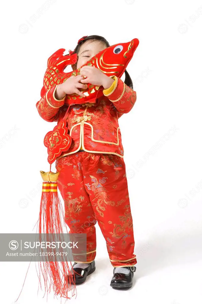 Young girl holding Chinese New Year fish