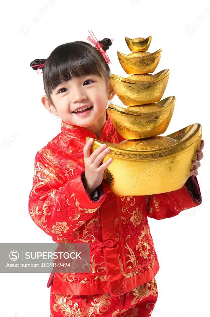 Young girl holding Chinese New Year gold ingot
