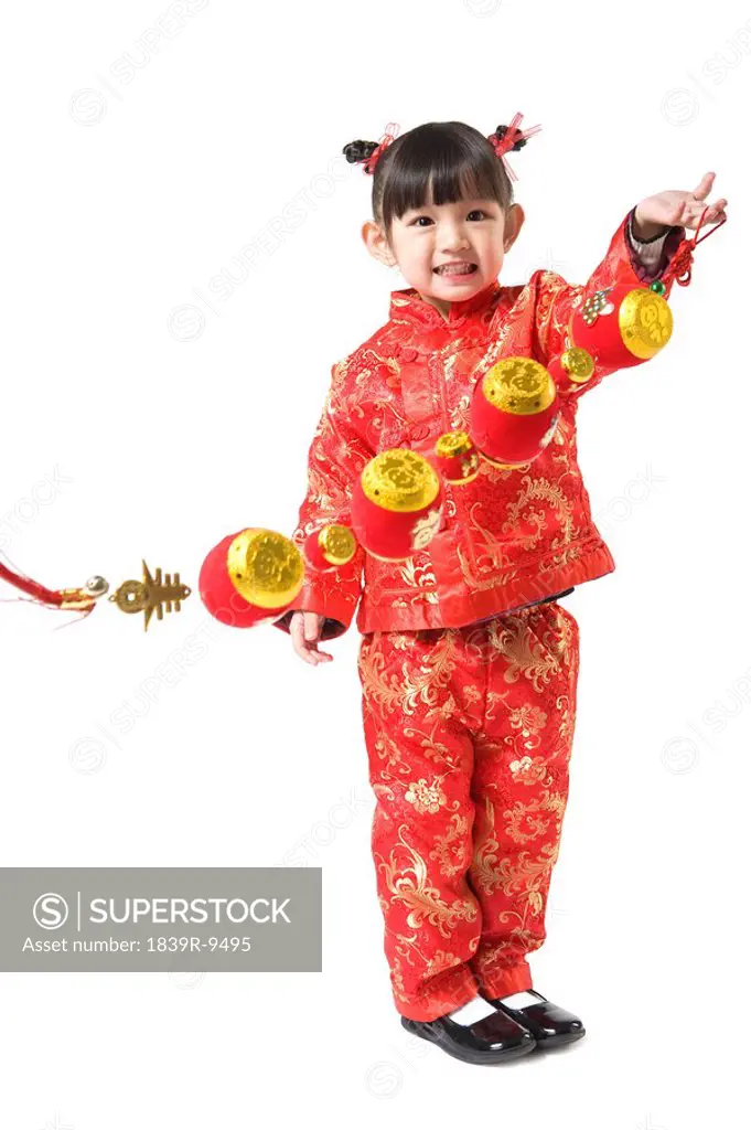 Young girl holding Chinese New Year gold ingot