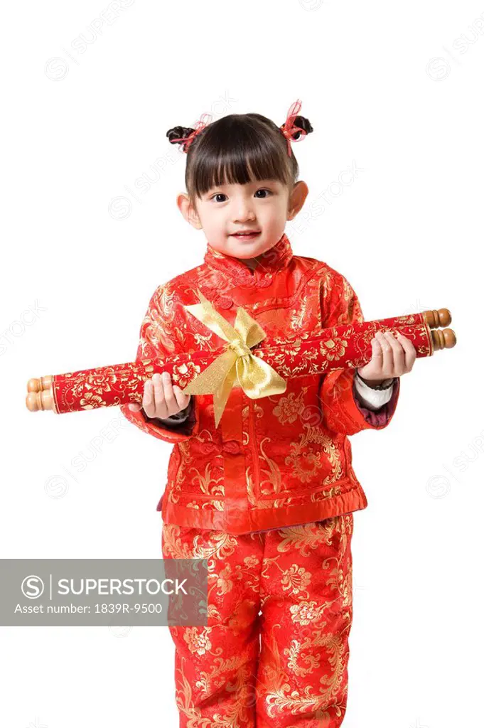 Young girl in Chinese traditional clothes holding scroll