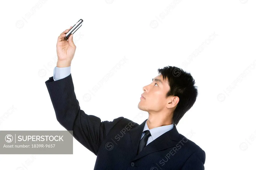 Young Businessman looking at cell phone