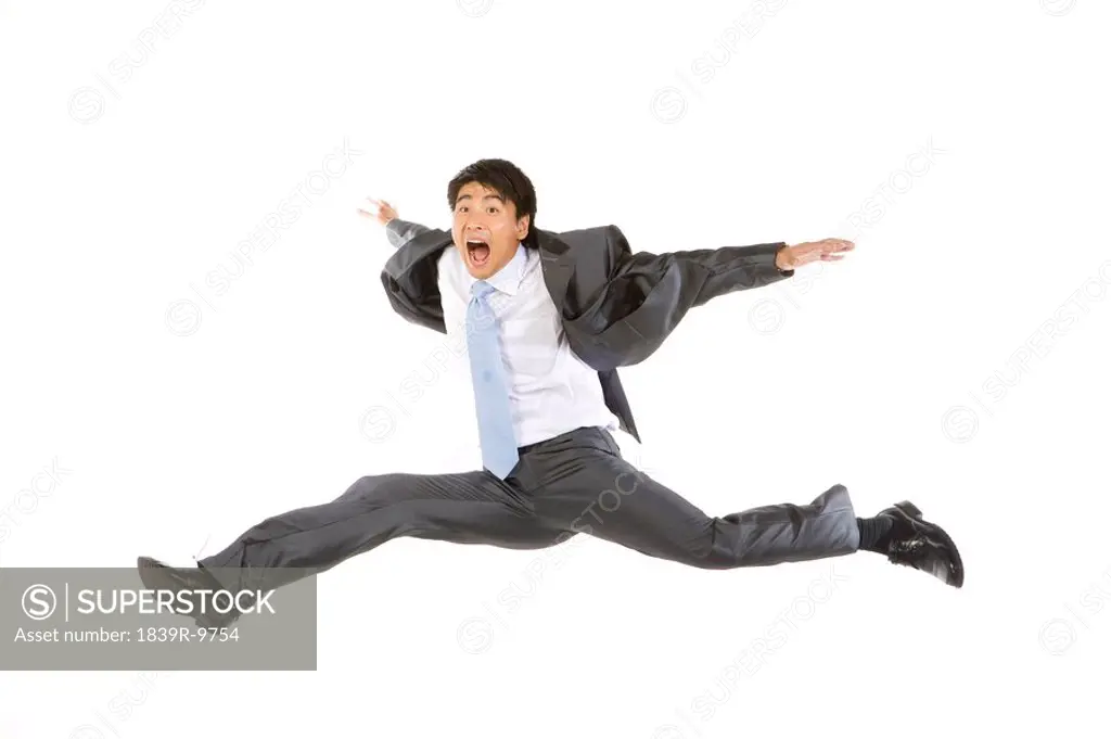 Young businessman jumping in mid_air