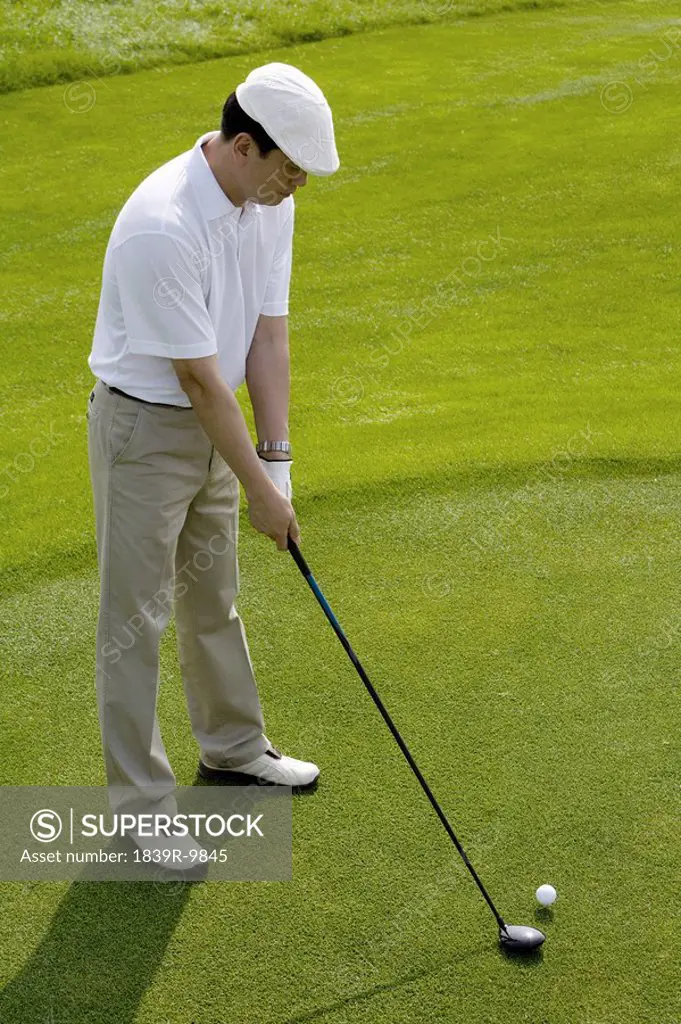 Male golfer teeing off