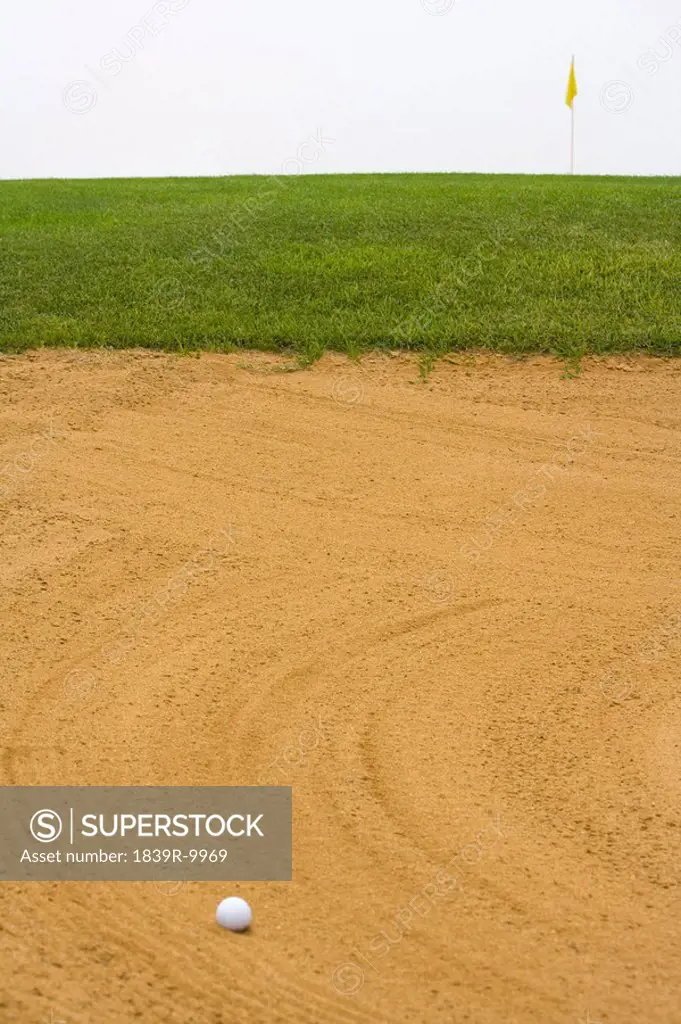 Golf ball in sand bunker