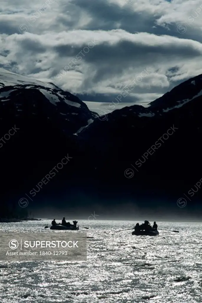 Rafting on the Alsek River just downstream of Tweedsmuir Glacier in British Columbia, Canada. Saint Elias Mountains loom in the background.