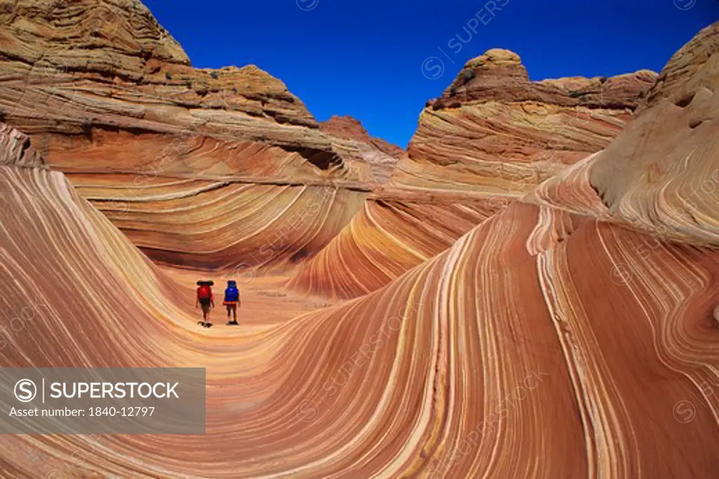 Two hikers in the Vermilion Cliffs Wilderness Area of northern Arizona.