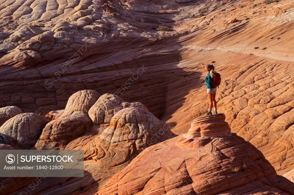 Hiker in the North Coyote Buttes area of the Vermilion Cliffs Wilderness Area, Arizona.