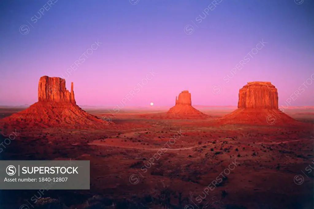 Moonrise between Mitten Buttes in Monument Valley, Navajo Nation, Arizona.