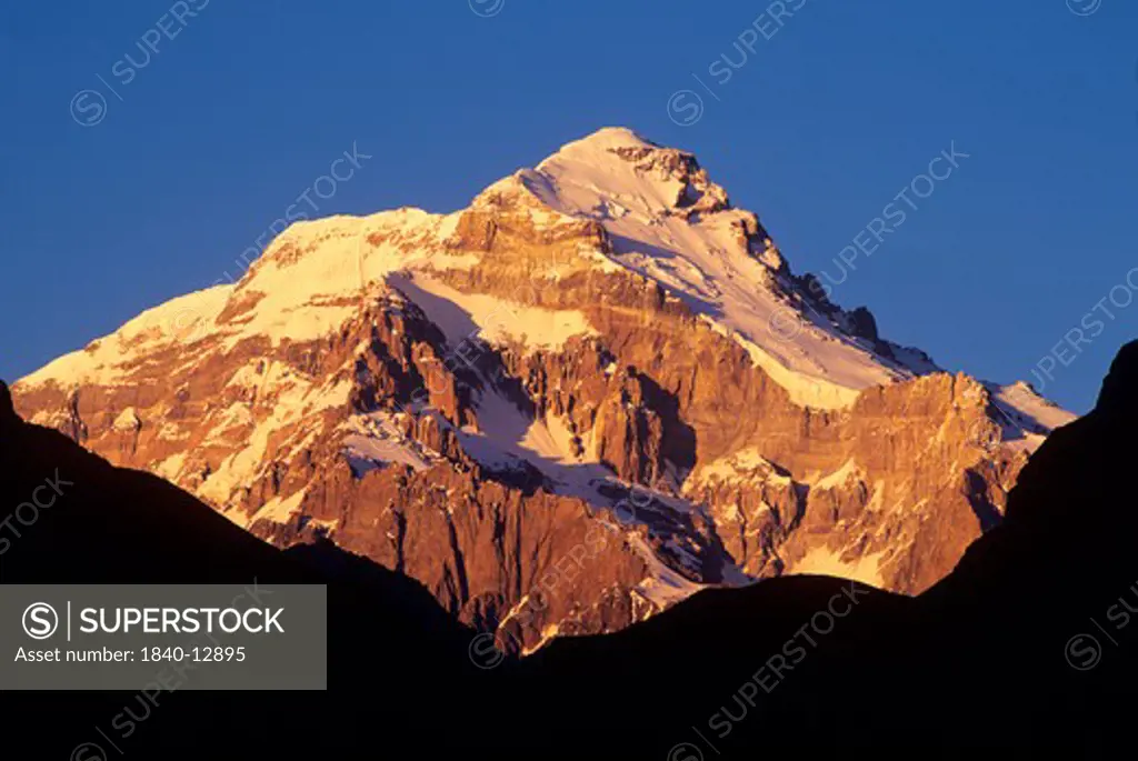 Morning light illuminates the east face of 22,841' Cerro Aconcagua viewed from the Vacas Valley in the Andes Mountains of Argentina. Aconcagua is the highest mountain in the world outside the Himalayas.