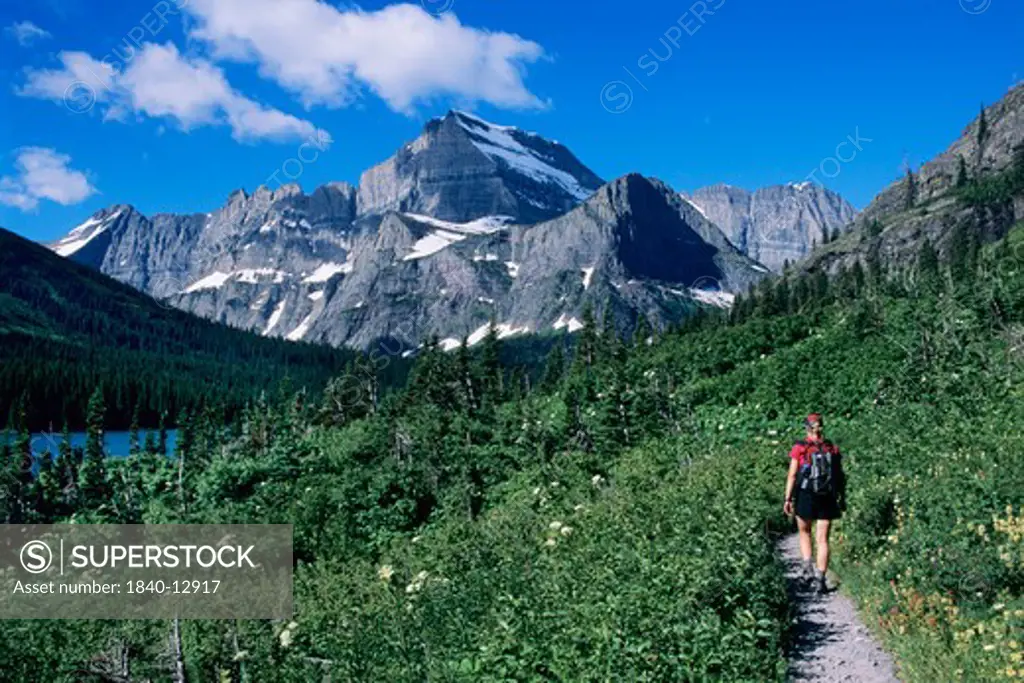 Hiking on Grinnell Glacier Trail below Mount Gould in the Many Glacier Region of Glacier National Park, Montana.