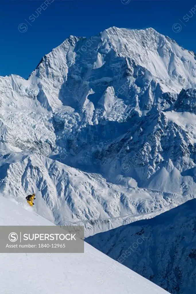 Helicopter skiing below 12,349' Mount Cook; highest mountain in New Zealand, Southern Alps, South Island.