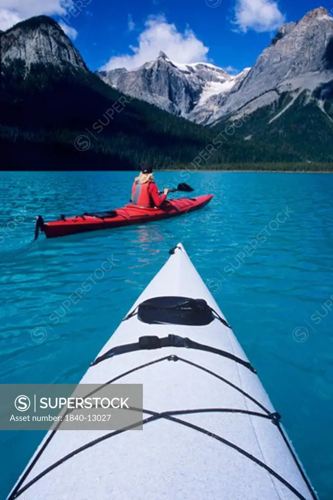 Kayaking on Emerald Lake beneath The President Range in Yoho National Park, British Columbia, Canada.