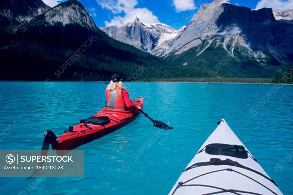Kayaking on Emerald Lake beneath The President Range in Yoho National Park, British Columbia, Canada.