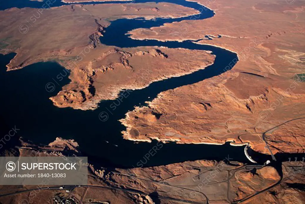 Aerial view of Glen Canyon Dam (lower right corner) and Lake Powell on the Utah/Arizona border with water level approximately 25 feet below full pool. Date: 1993