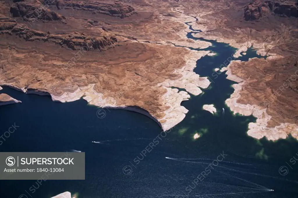 Powerboats buzz across the surface of Lake Powell in this aerial view of Wetherill Canyon showing the reservoir's white ""bathtub ring"" staining the sandstone