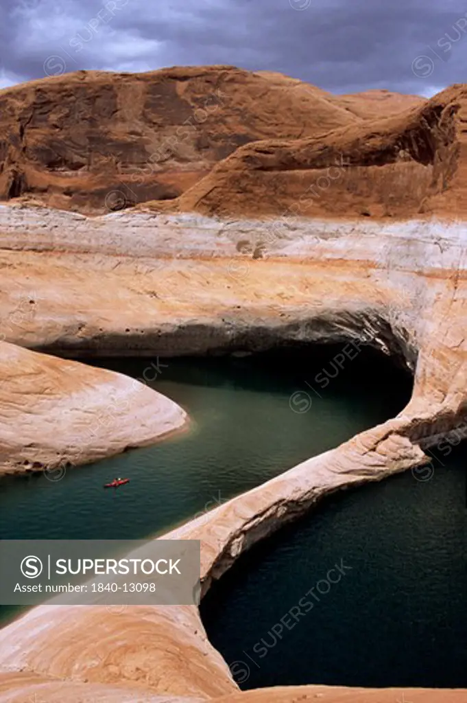 Kayaking on Lake Powell in Reflection Canyon with water level of reservoir 140 feet below full-pool elevation due to a prolonged western drought which began in 1999.