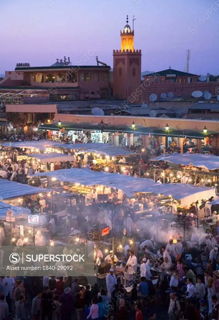 Jemaa El Fna Square in Marrakech with food stalls and fruit sellers at nightime. Morocco