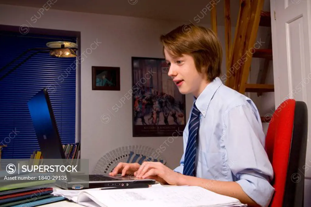 Teenage Boy studying and using Laptop Computer