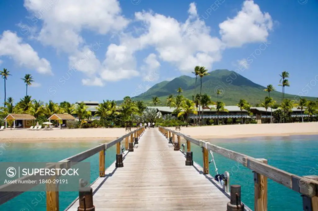 Stunning Pinney's beach with Coconut Palms, and the Volcano in the distance, at Nevis. Caribbean