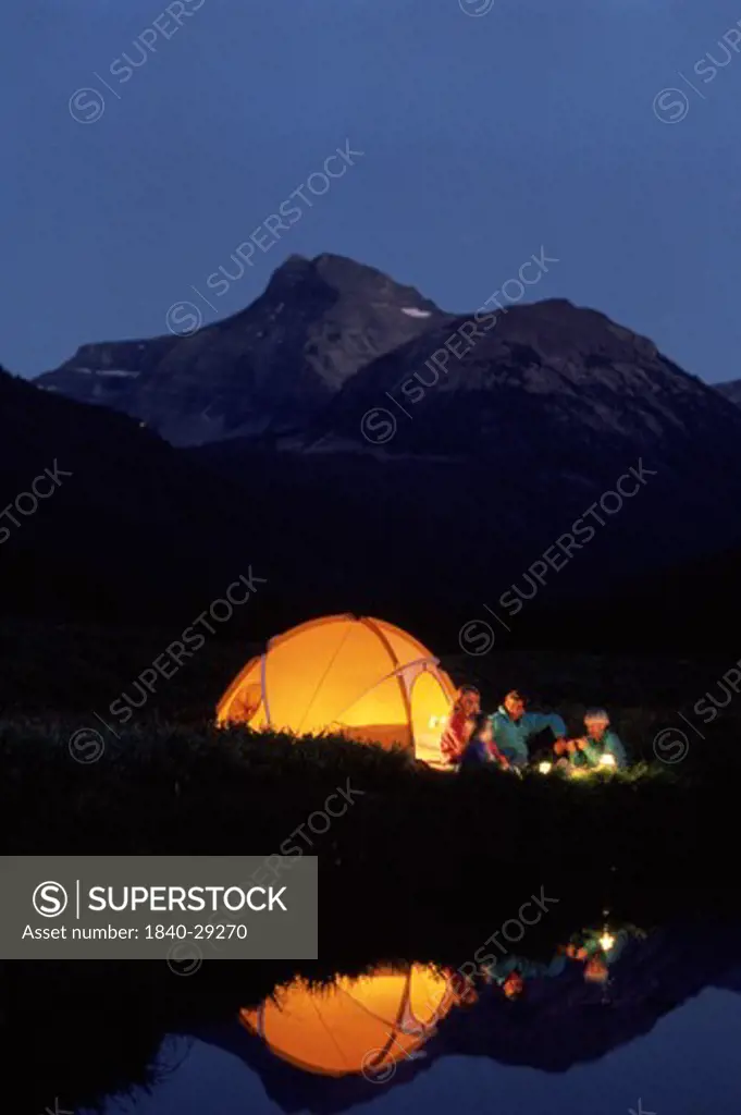 Family camping along the Stillwater Fork of the Bear River in Christmas Meadows in the Uinta Mountains of northern Utah. Ostler Peak in the distance.