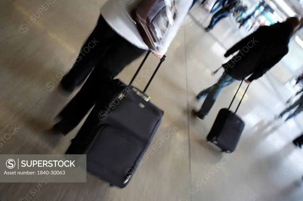 Travellers On The Move With Luggage