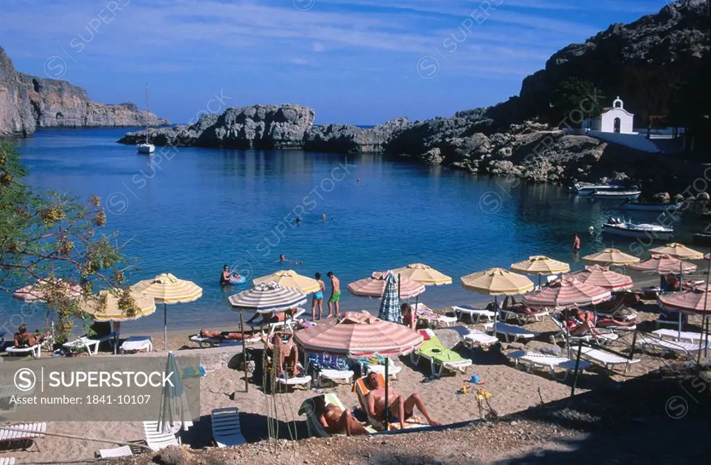 Tourists relaxing on coast, Lidos Beach, Rhodes, Greece