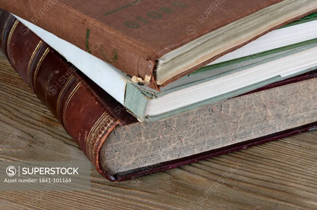 Pile of old books on wooden table, close_up