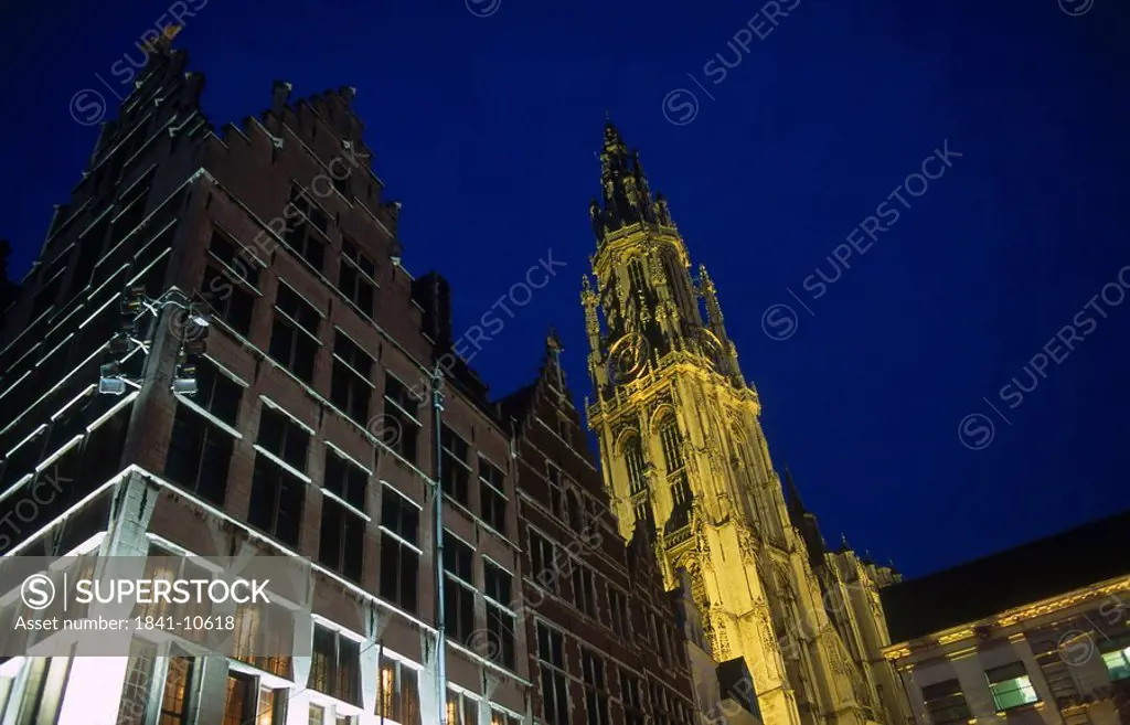 Low angle view of cathedral lit up at night, Antwerp, Belgium