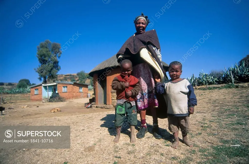 Low angle view of woman standing with her grandchildren