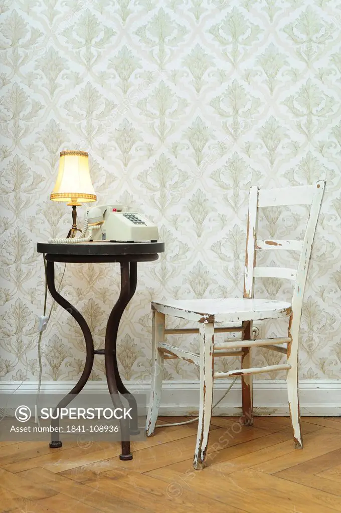 Chair and table with lamp and telephone