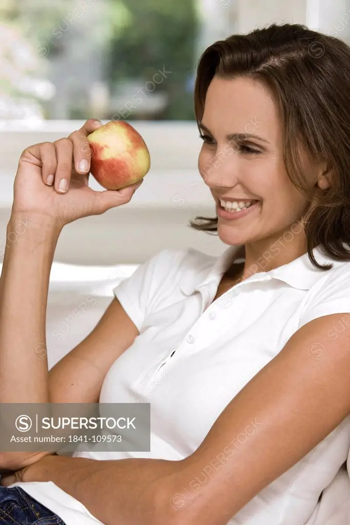 Smiling woman holding an apple