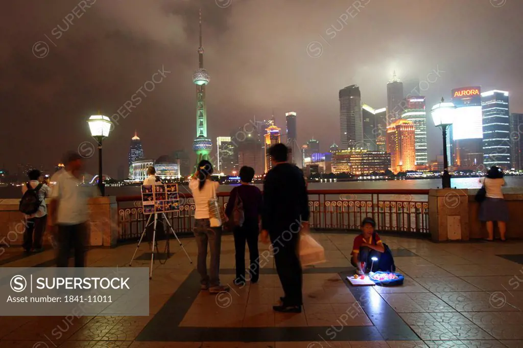 Tourists looking at city view, Huangpu River, Oriental Pearl Tower, Jin Mao Tower, Pudong, Shanghai, China