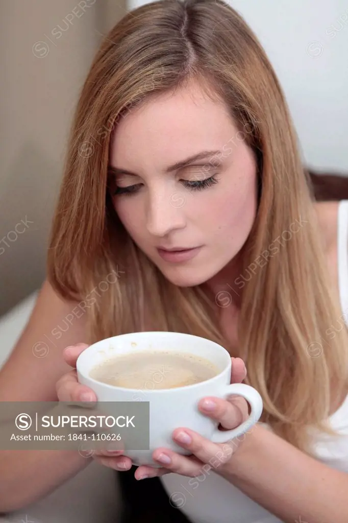 Young woman with cup of coffee
