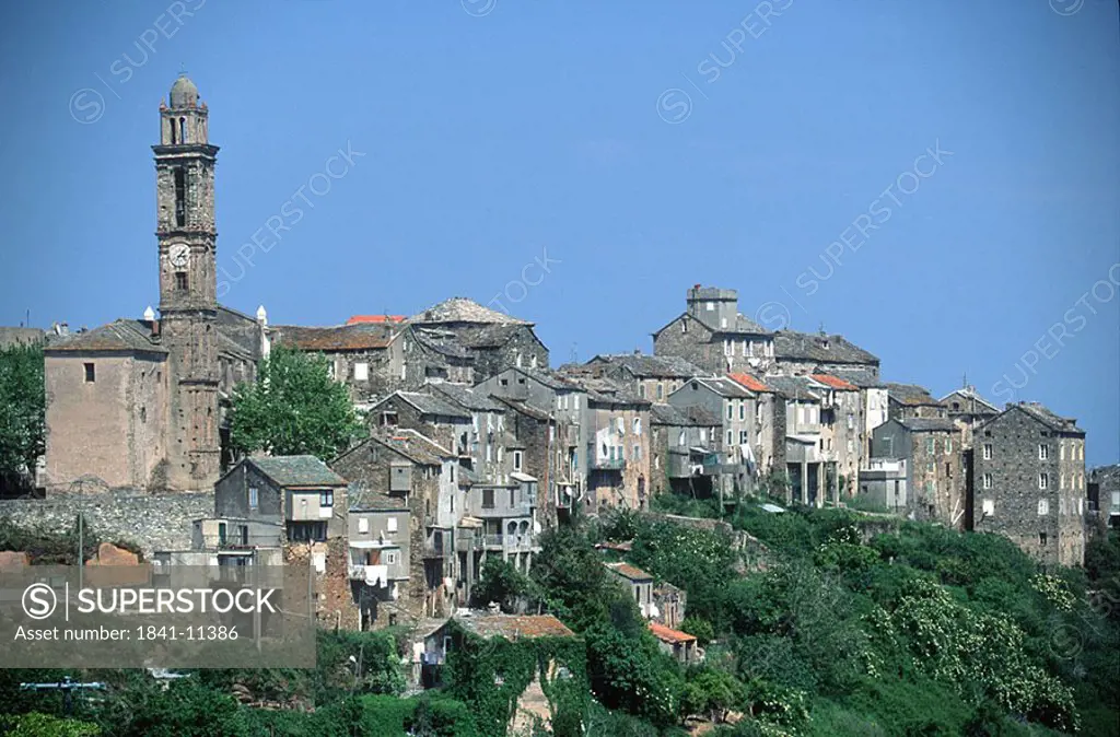 Town on hill against blue sky, Venzolasca, Corsica, France