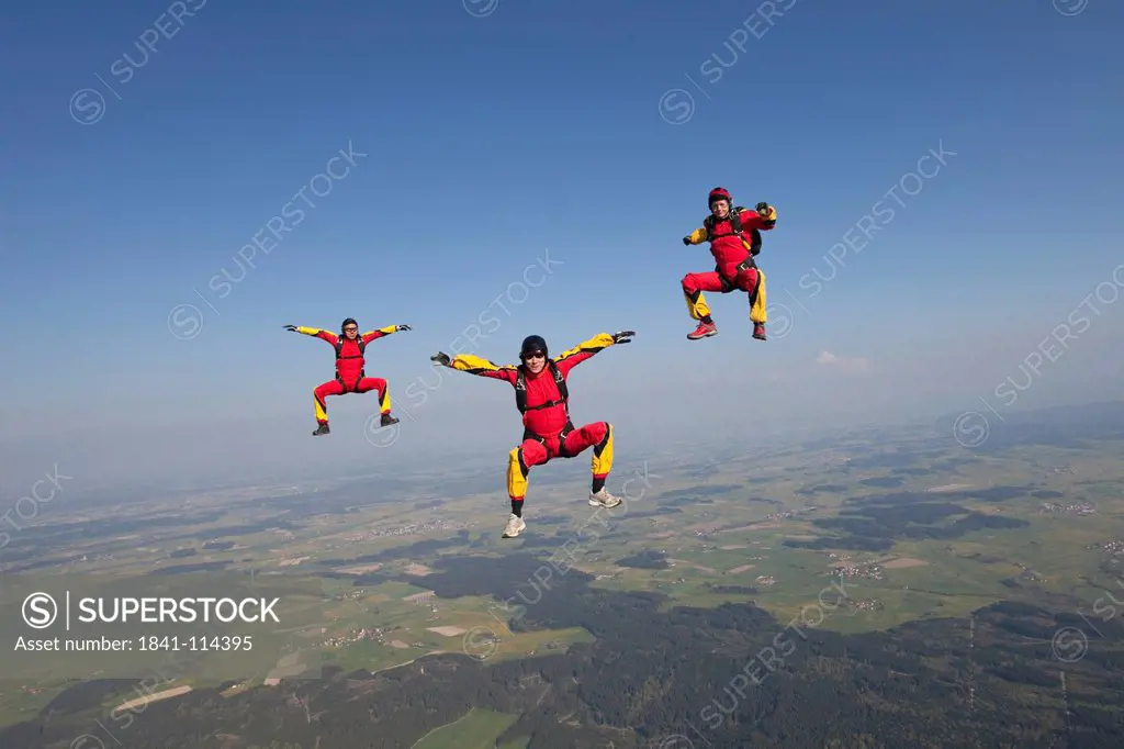 Three skydivers in the air