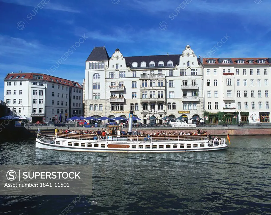 Tourists traveling on tourboat in river, River Spree, Nicolaiviertel, Germany