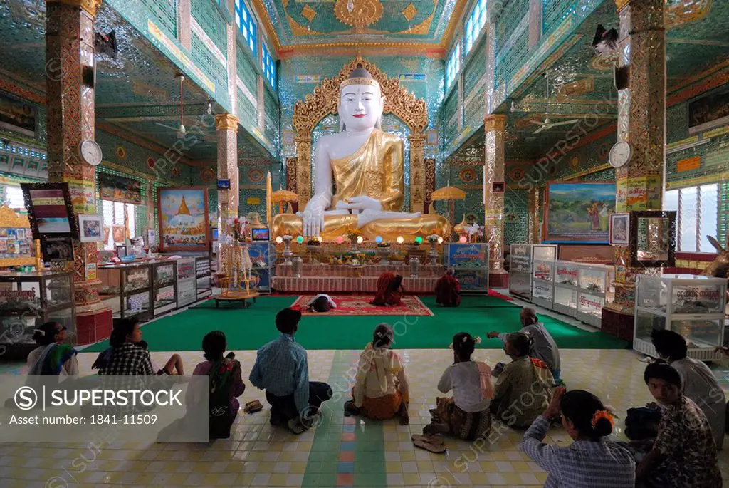 Group of devotees in front of Buddha statue inside Buddhist temple, Soon U Ponya Shin Pagoda , Mandalay, Myanmar