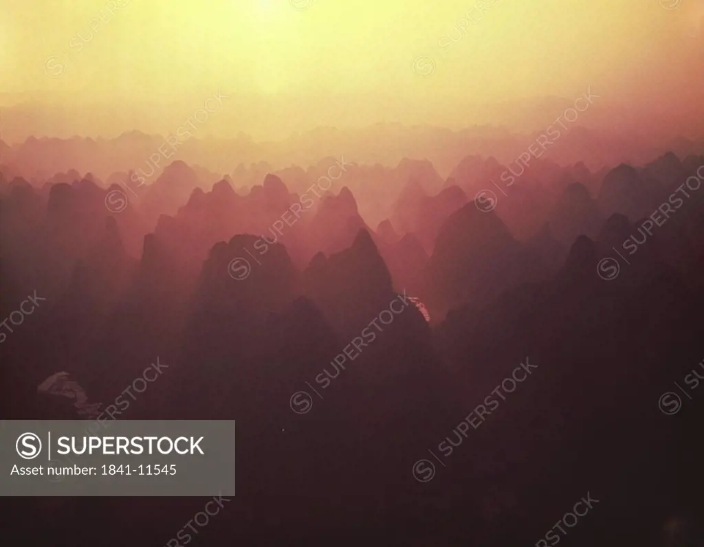 Silhouette of rock formations at dusk, China