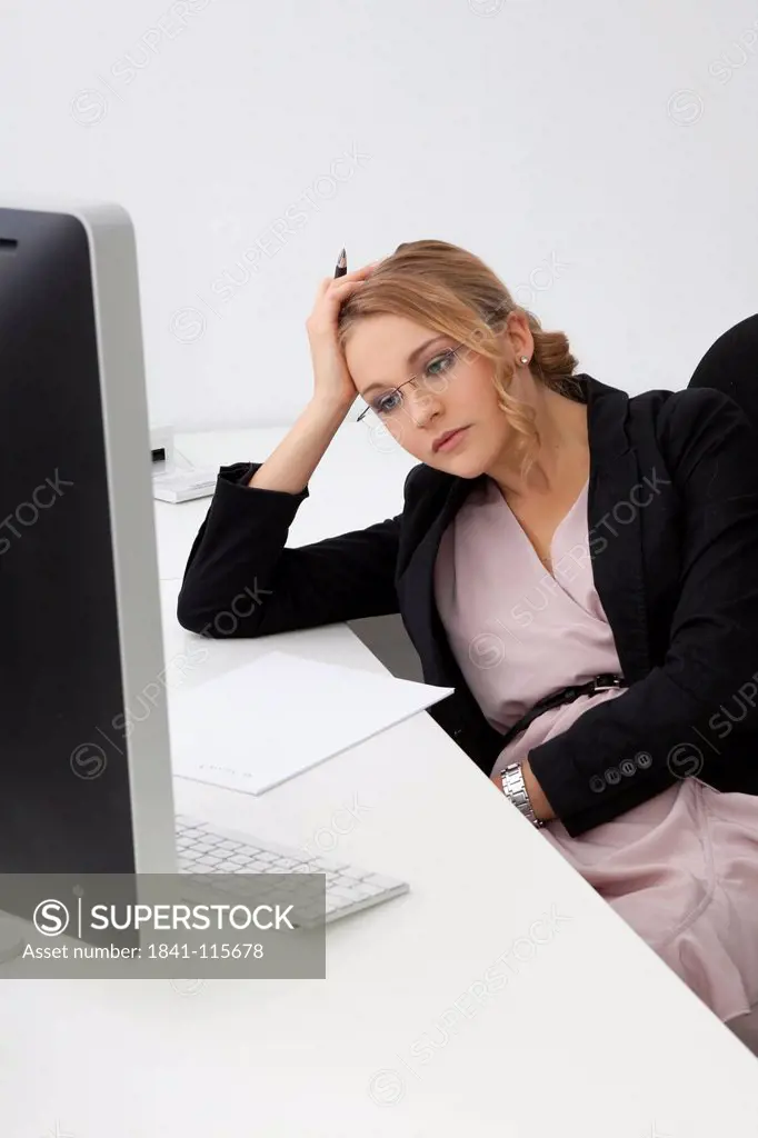 Frustrated young woman in office